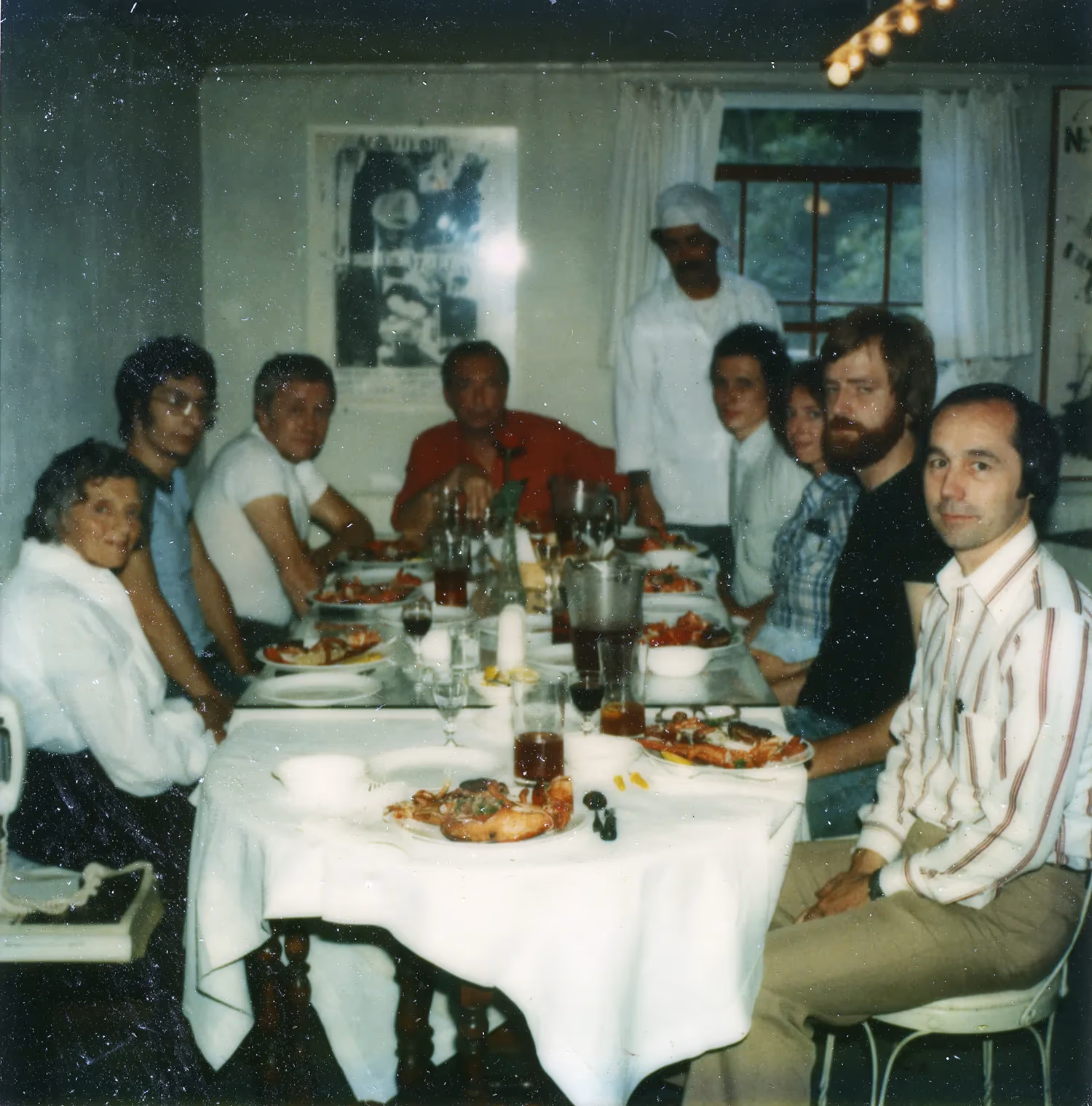 Jasper Johns and ULAE staff sitting around the lunch table at Skidmore Place