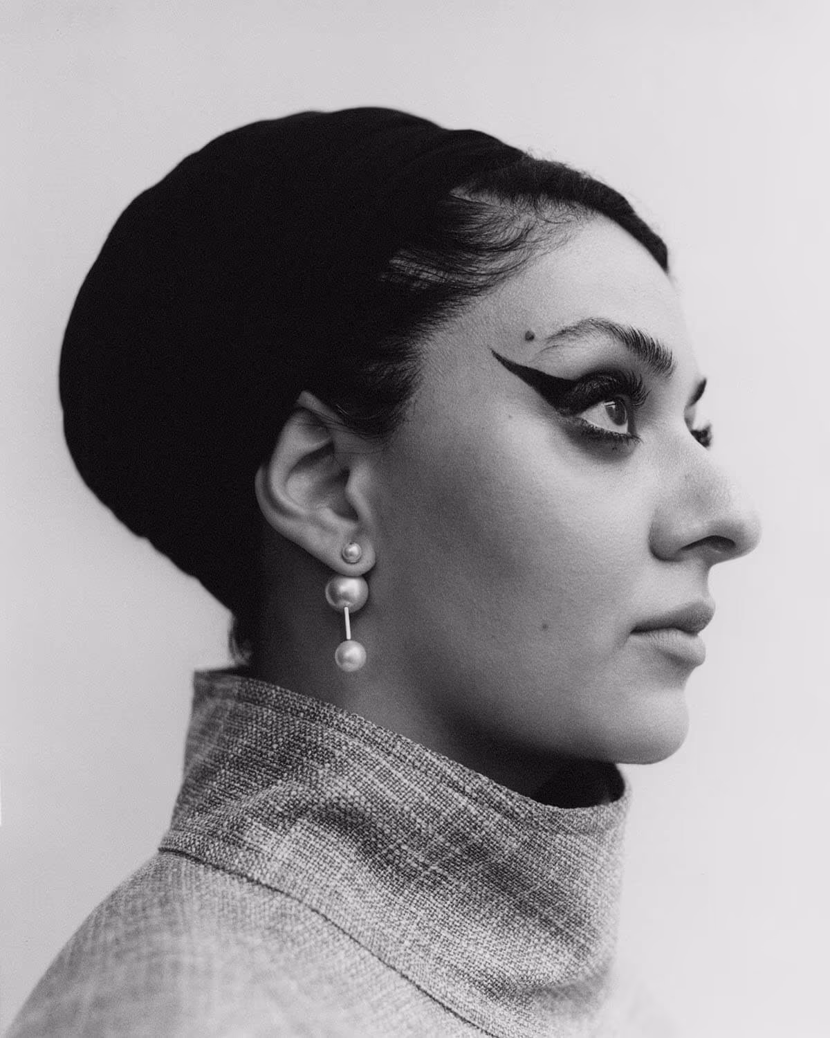 Sumayya Vally wears jacket by LORO PIANA and earrings by CHRISTIAN DIOR.