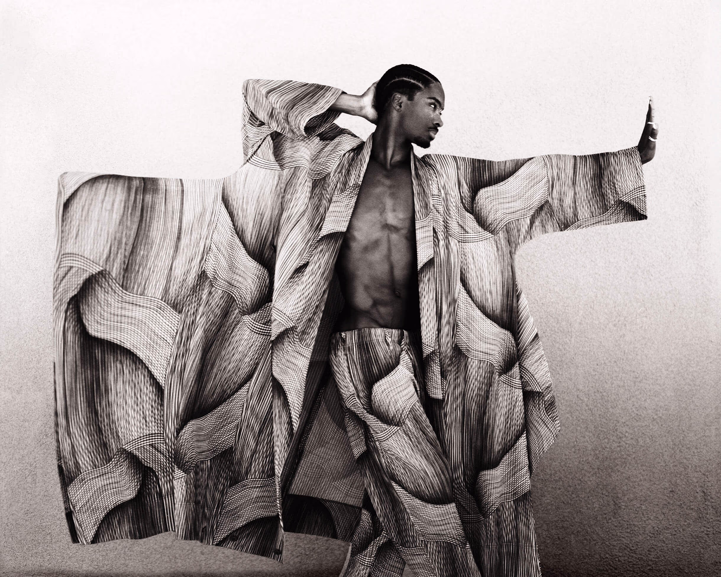 Alton wears jacket and pants by HOMME PLISSÉ ISSEY MIYAKE and trinity rings by CARTIER.