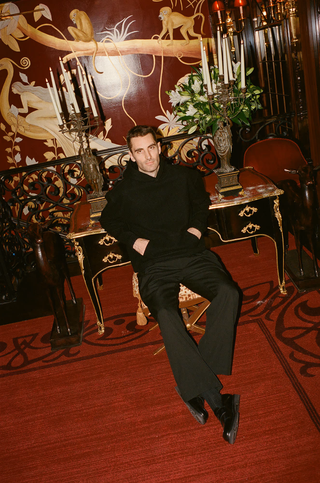 Kyle wears hoodie by RIER and shoes by JOHN LOBB.