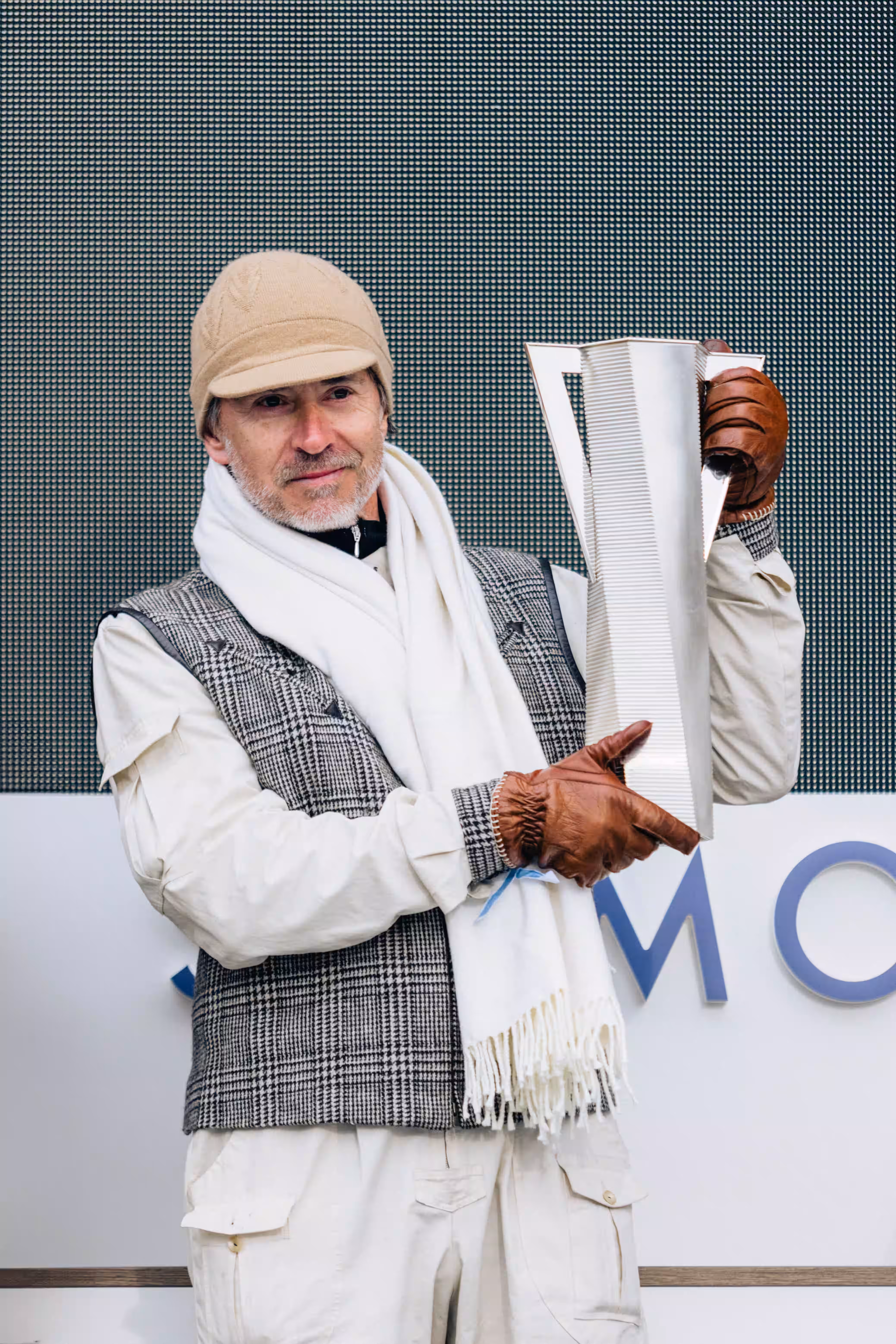 Marc Newson with his Lord Norman Foster-designed award. Image courtesy of the International Concours of Elegance St. Moritz.