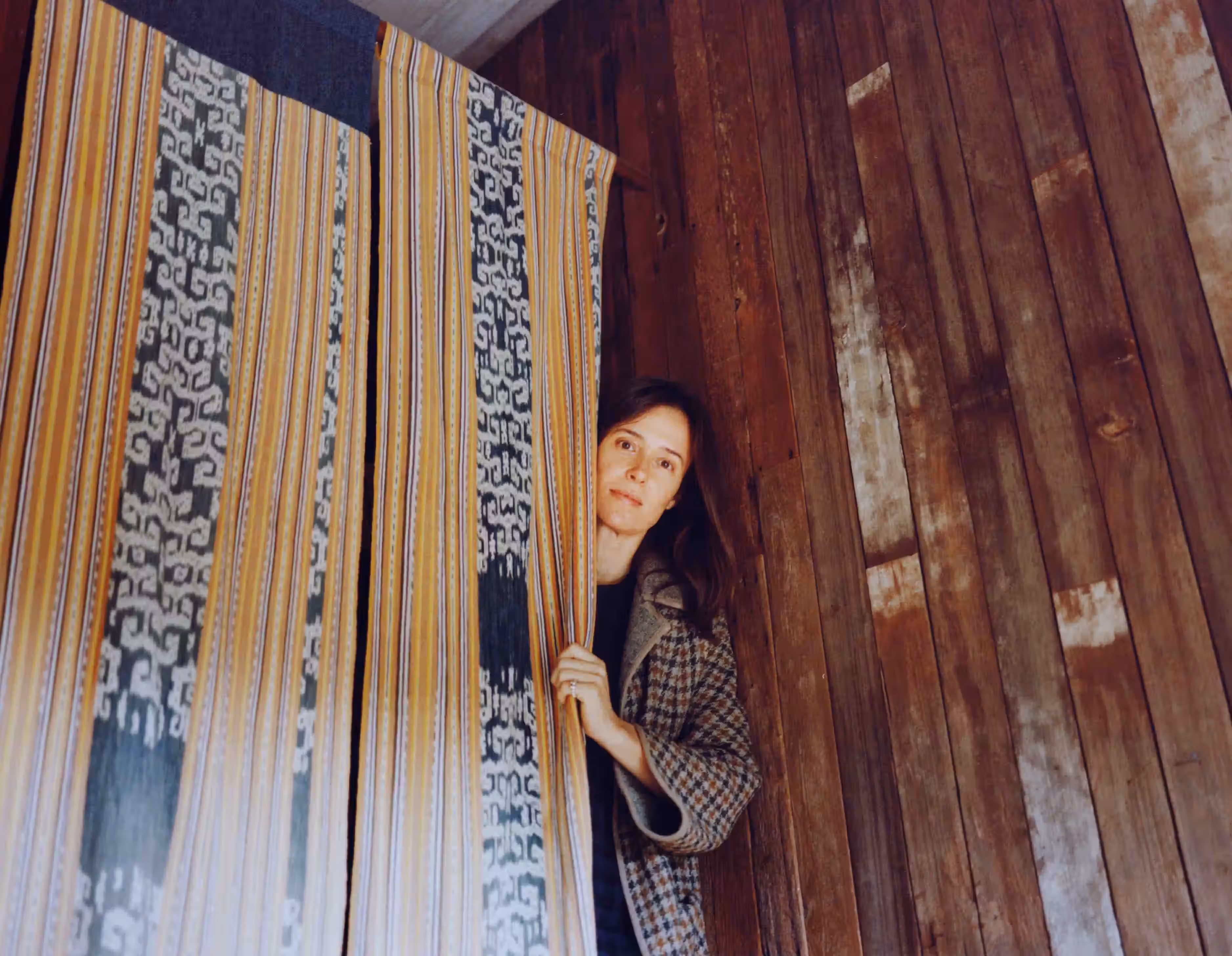 Mariah Nielson with curtains made by her using fabric her father brought back from Indonesia.