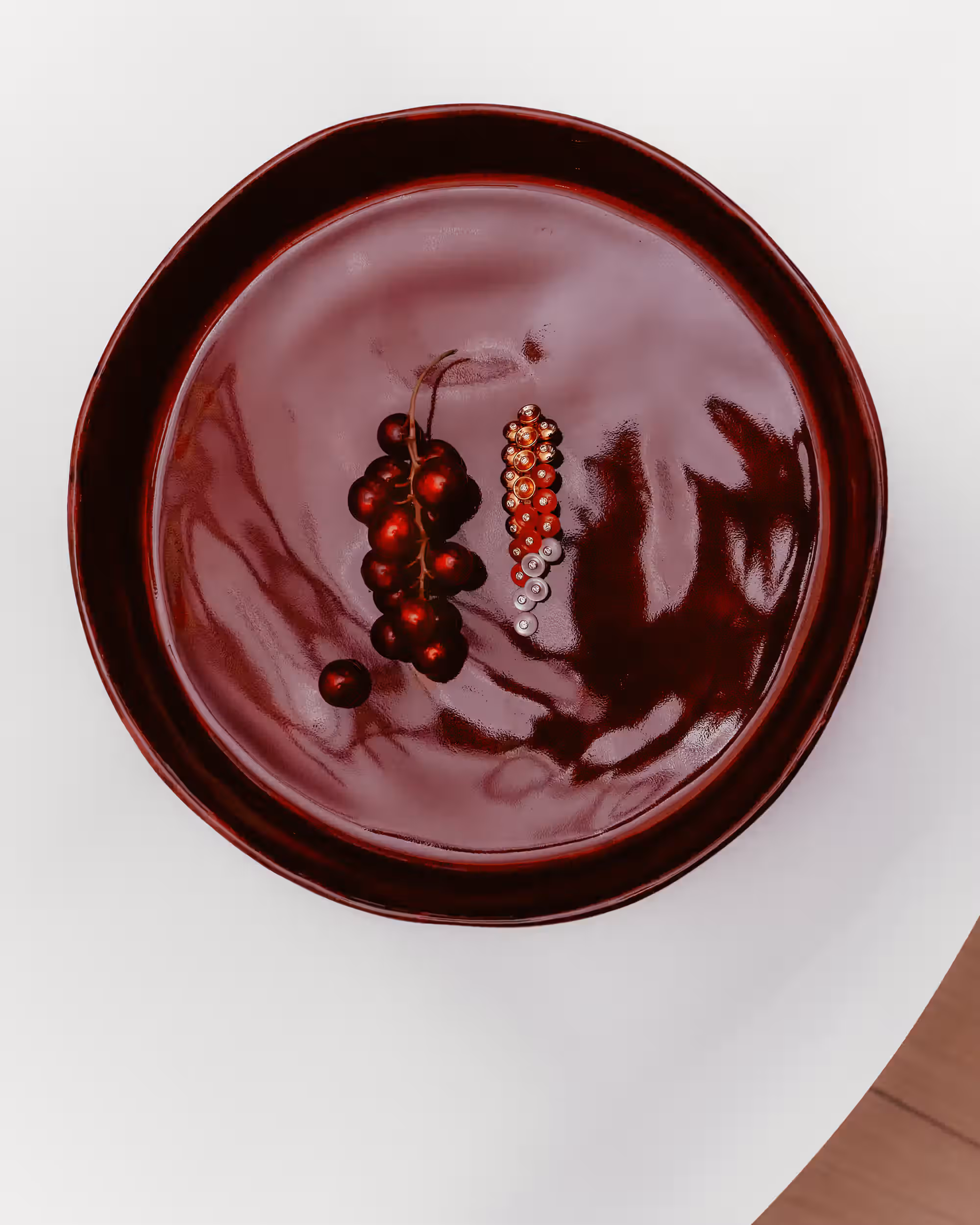 Earring by VAN CLEEF & ARPELS and plate by MARIE MICHIELSSEN for SERAX.