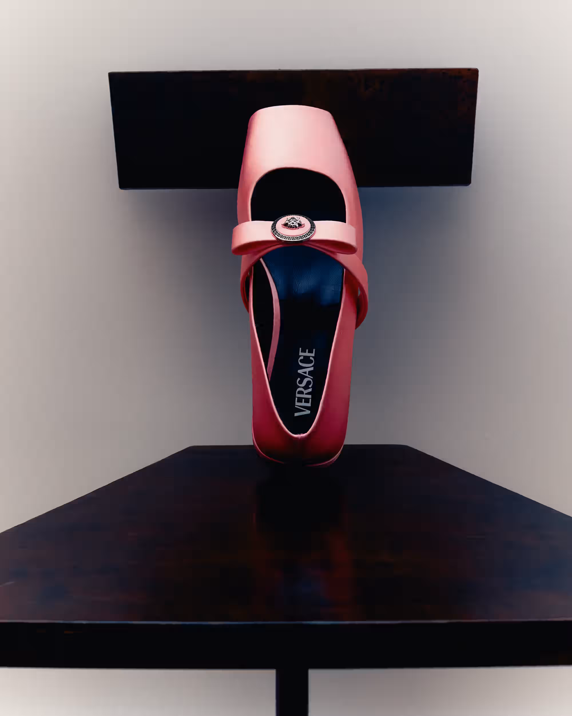 Shoe by VERSACE and chair by CAL SUMMERS.