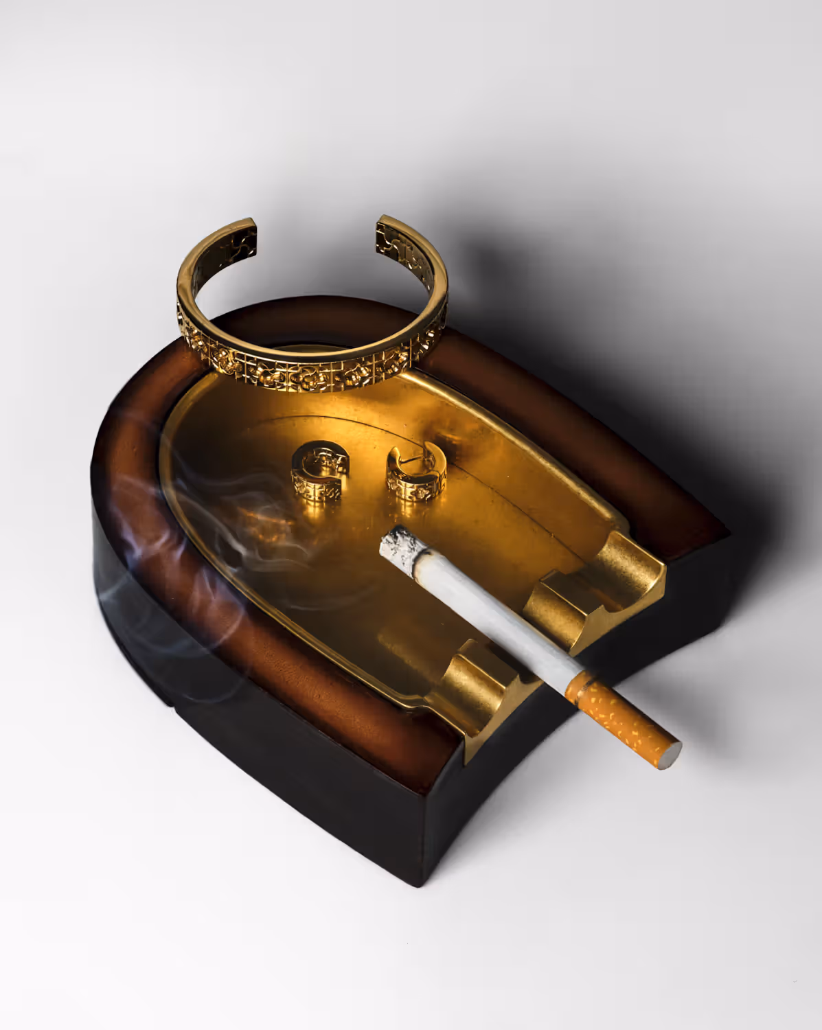 Cuff and earrings by BURBERRY and ashtray by BERLUTI.