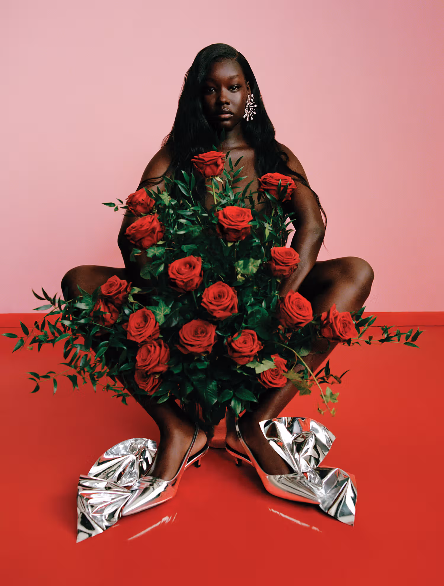 Ajok wears earrings by BOUCHERON and shoes by ERDEM.