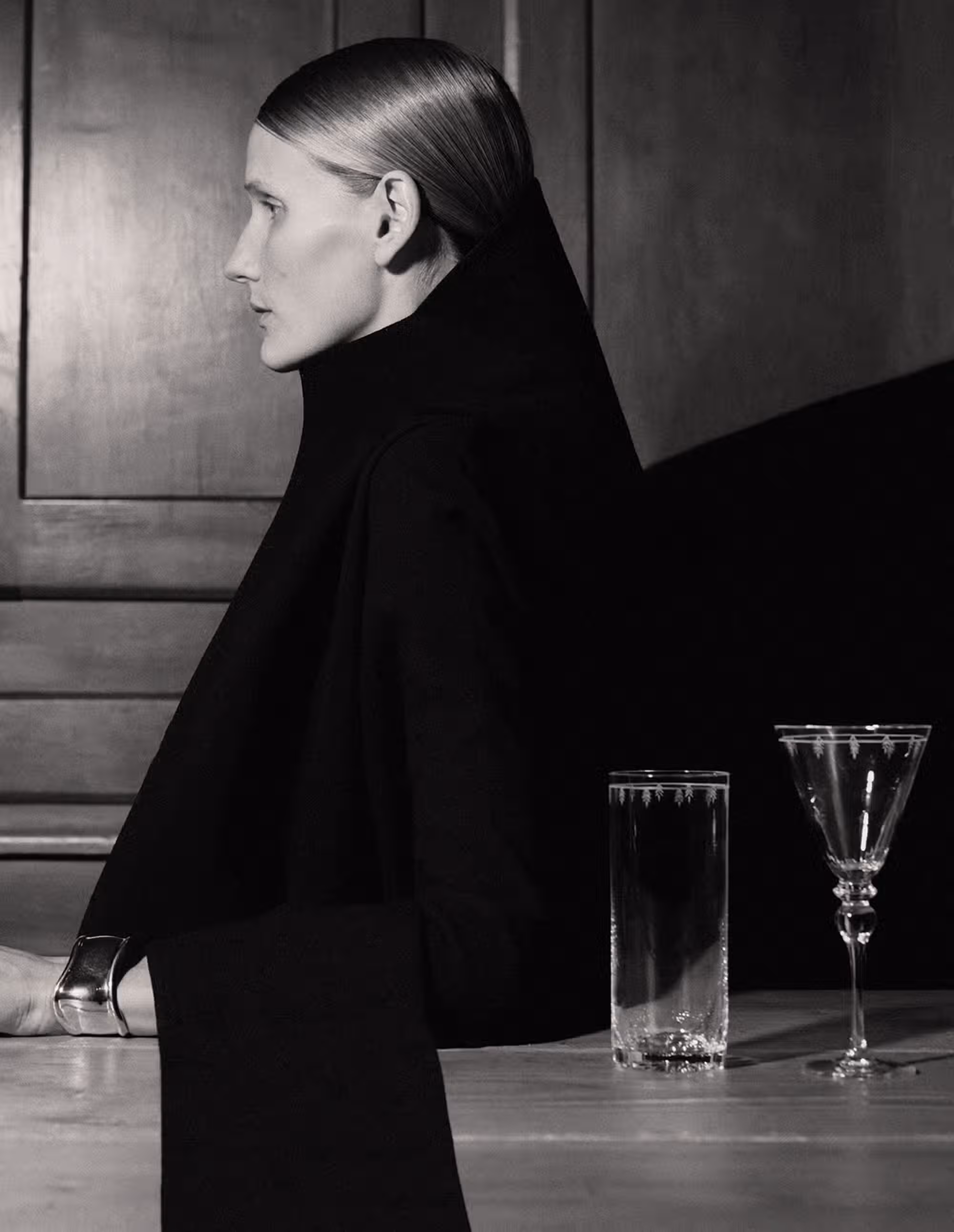 Helga Hitko wears coat by GEOFFREY BEENE from ETÉREO VINTAGE and bracelet by TIFFANY & CO. Glassware by TIFFANY & CO.