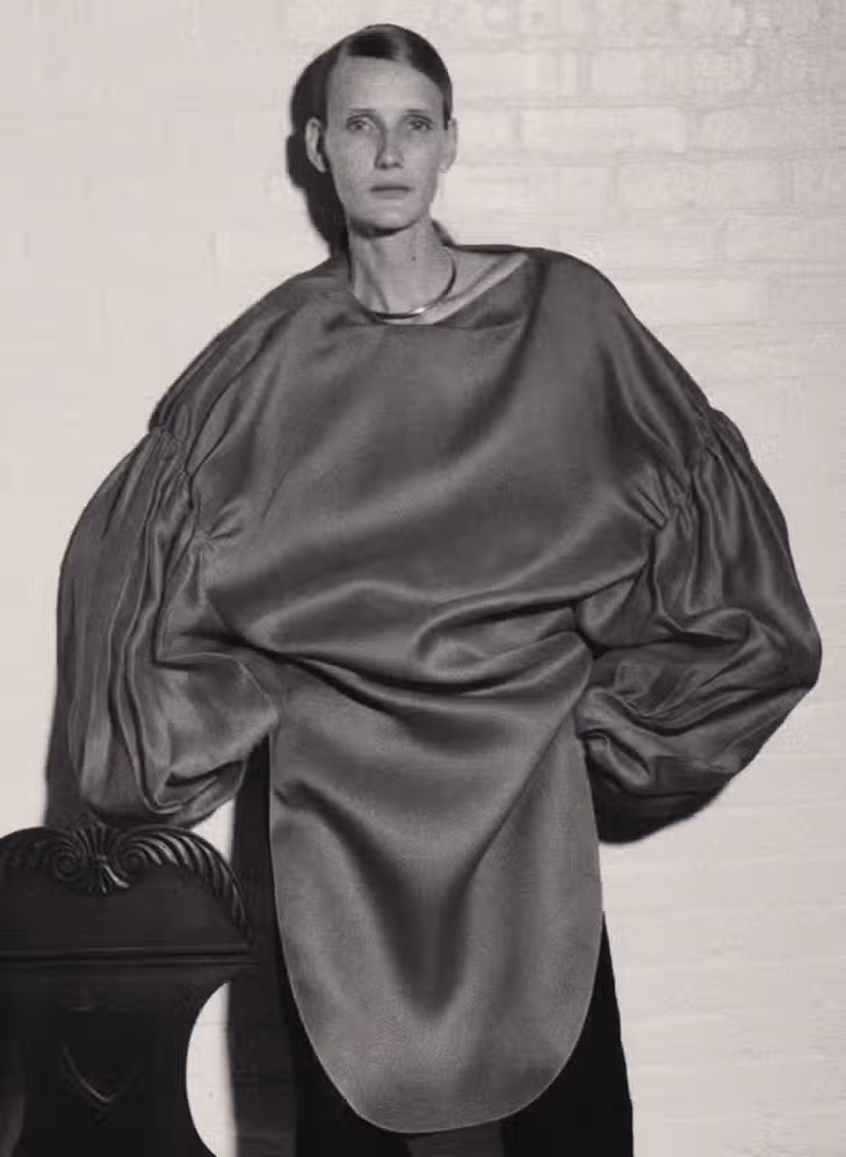 Helga wears dress by KHAITE and necklace by POMELLATO.