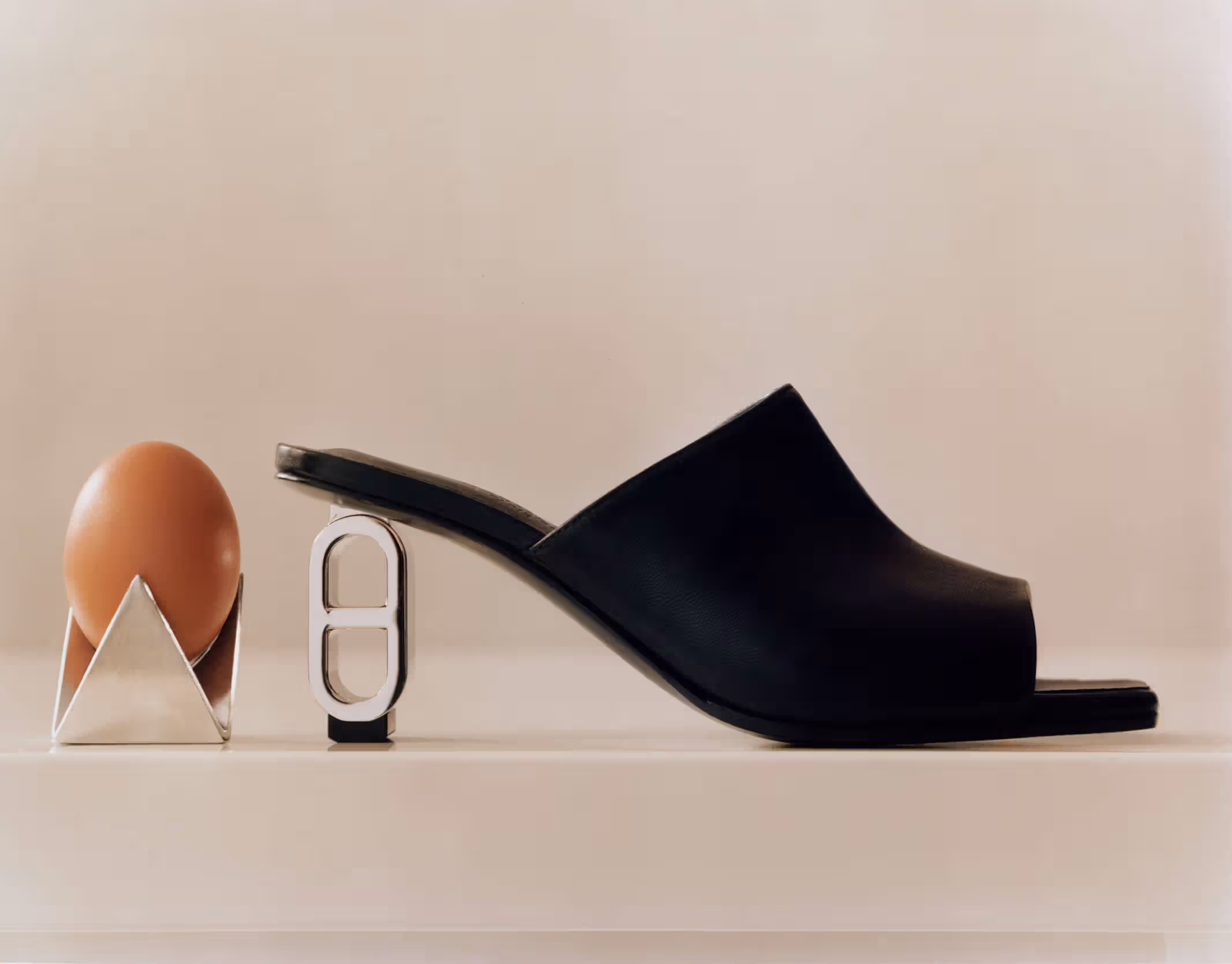 Egg cup by ADAM GOODRUM FOR ALESSI and shoe by HERMÈS.