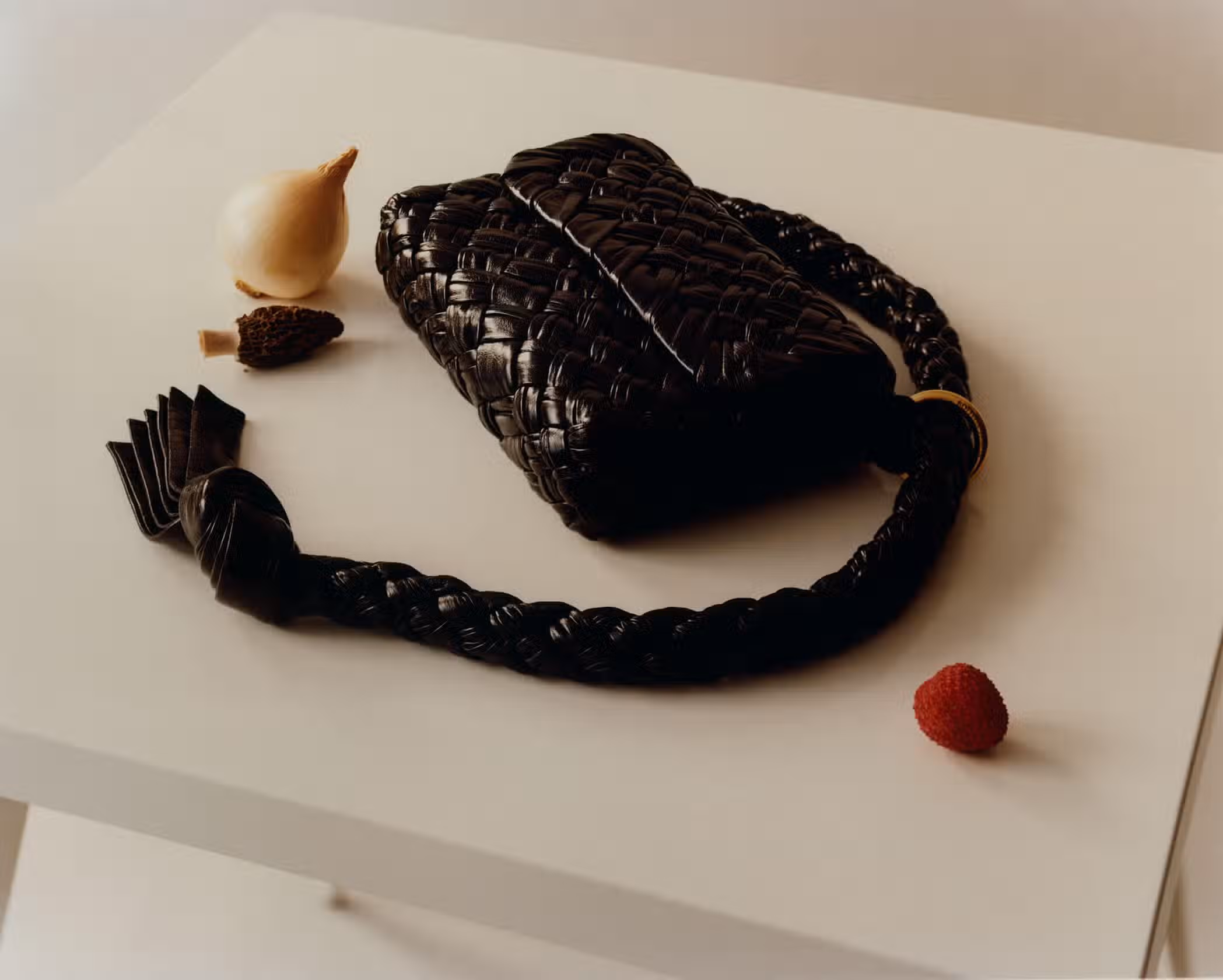 Bag by BOTTEGA VENETA and table by TOLIX.