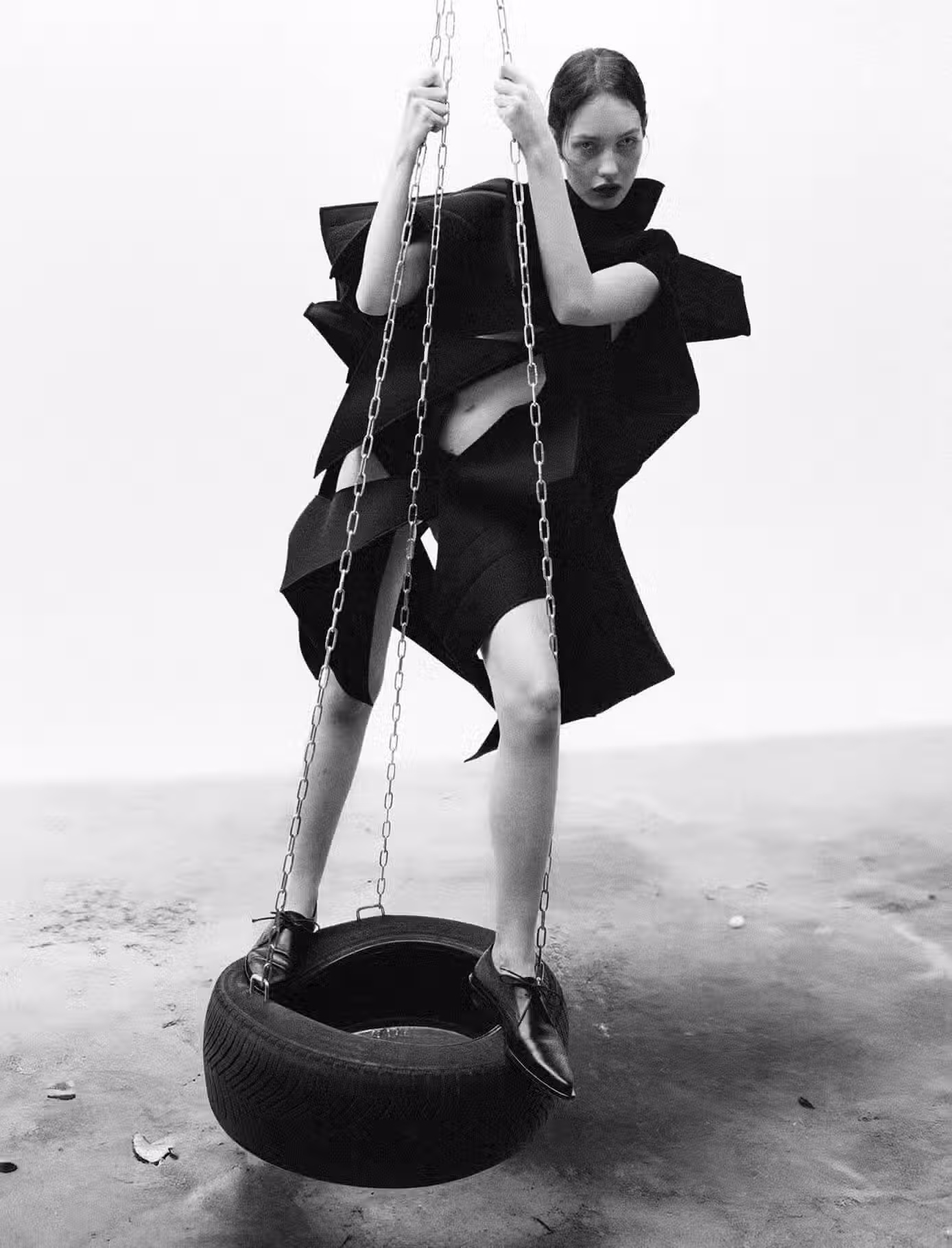 Clara wears dress by JUNYA WATANABE and shoes by ANN DEMEULEMEESTER.