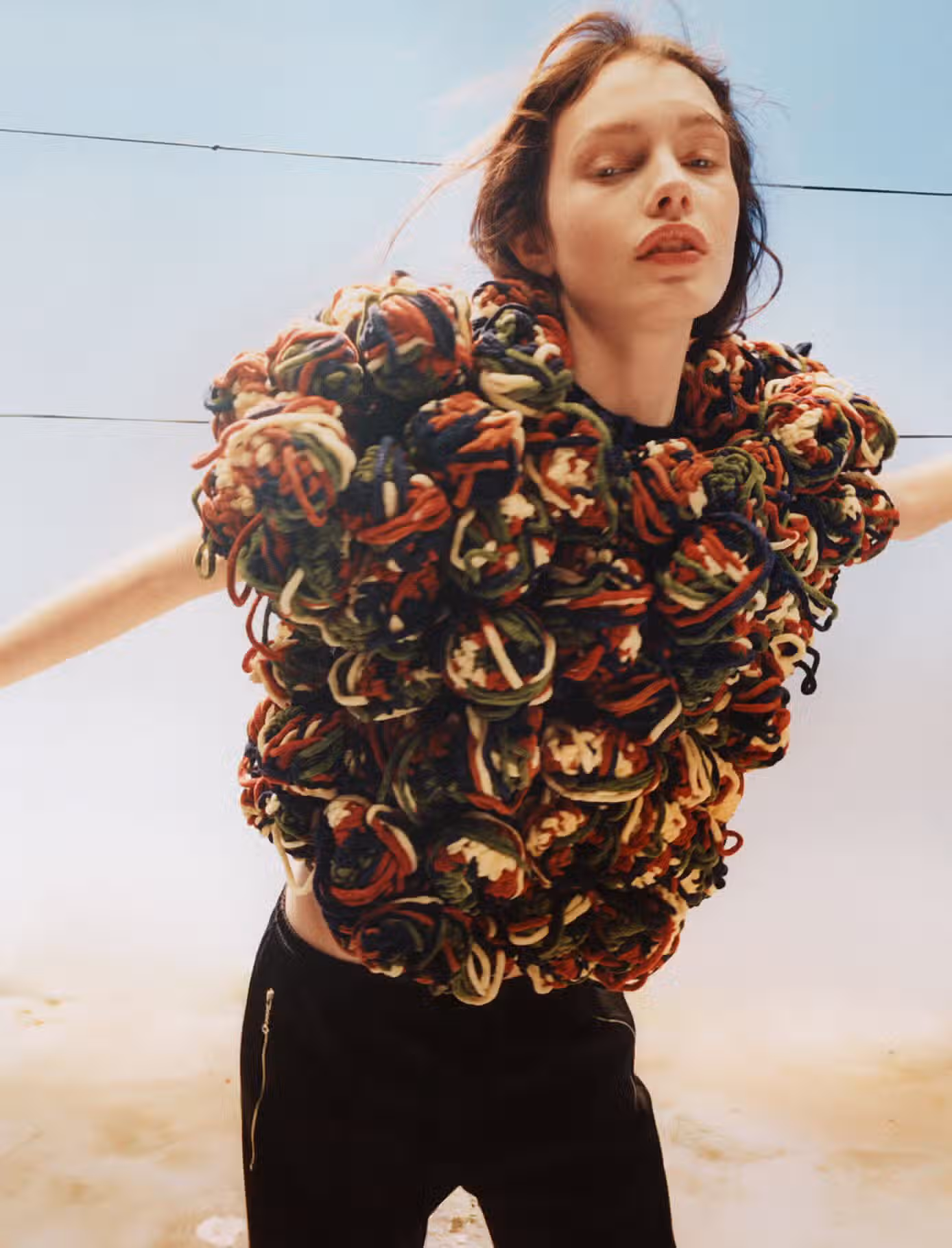 Clara wears full look by JW ANDERSON.