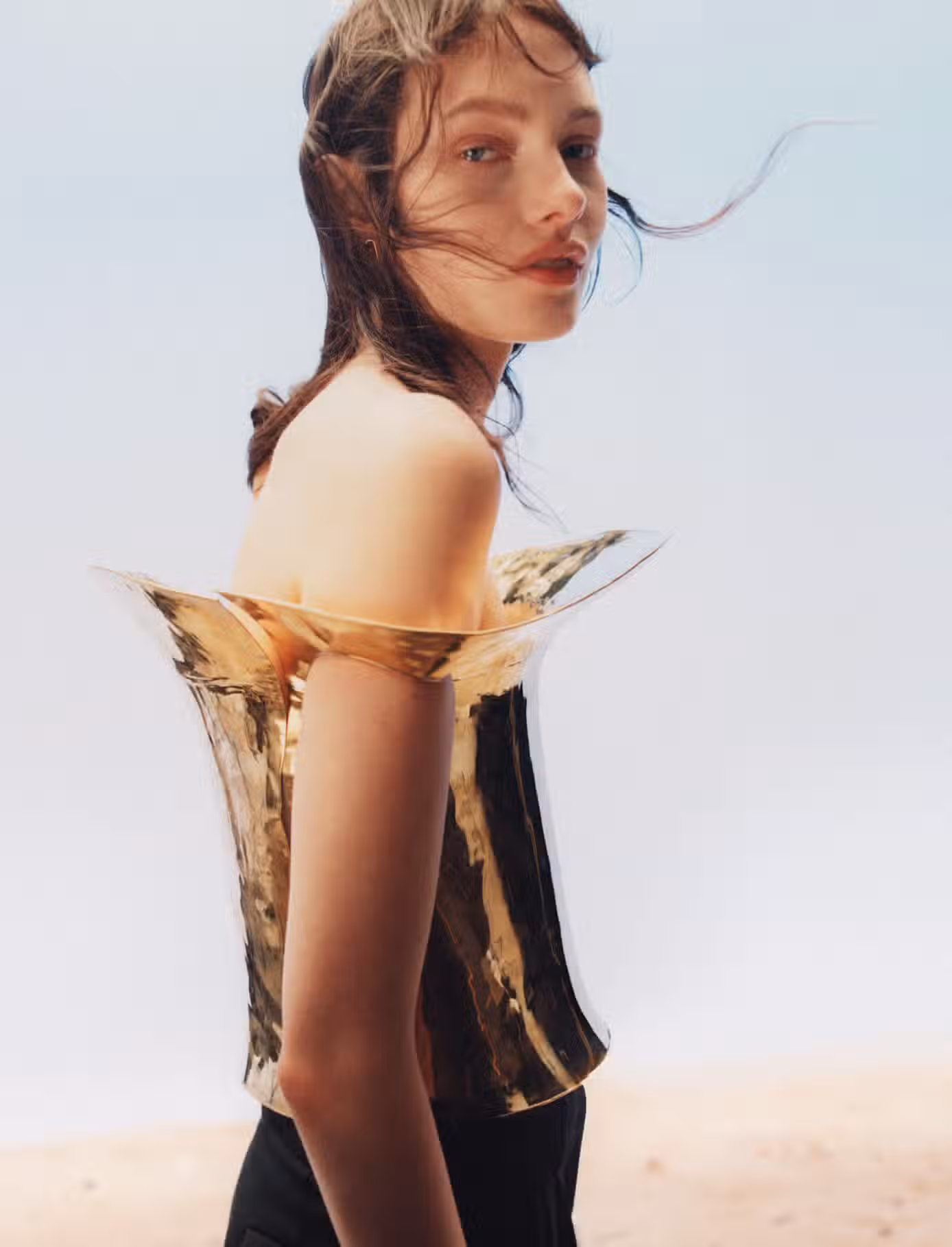 Clara wears top and pant by COPERNI and earrings by POMELLATO.
