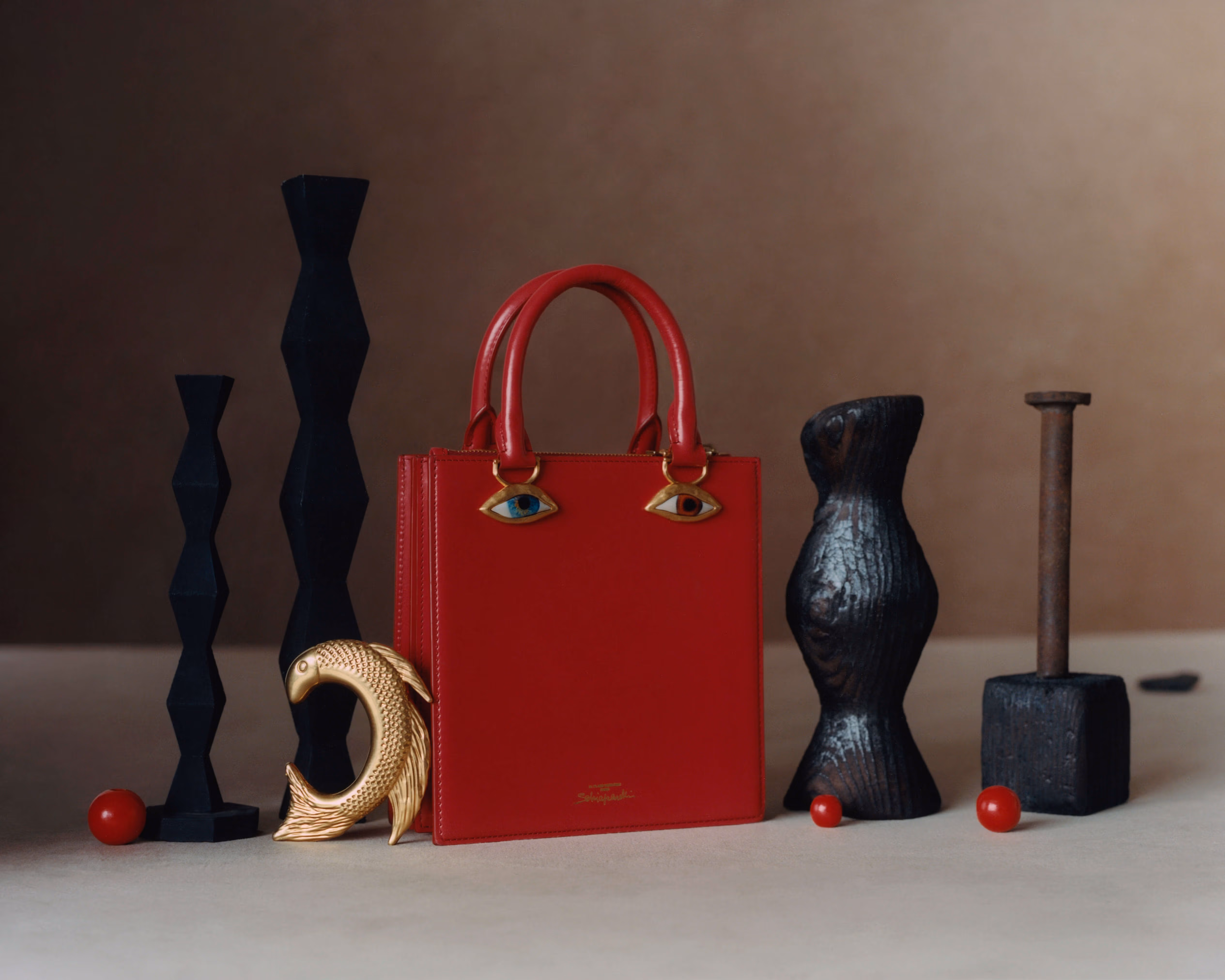 Bag and bracelet by SCHIAPARELLI.