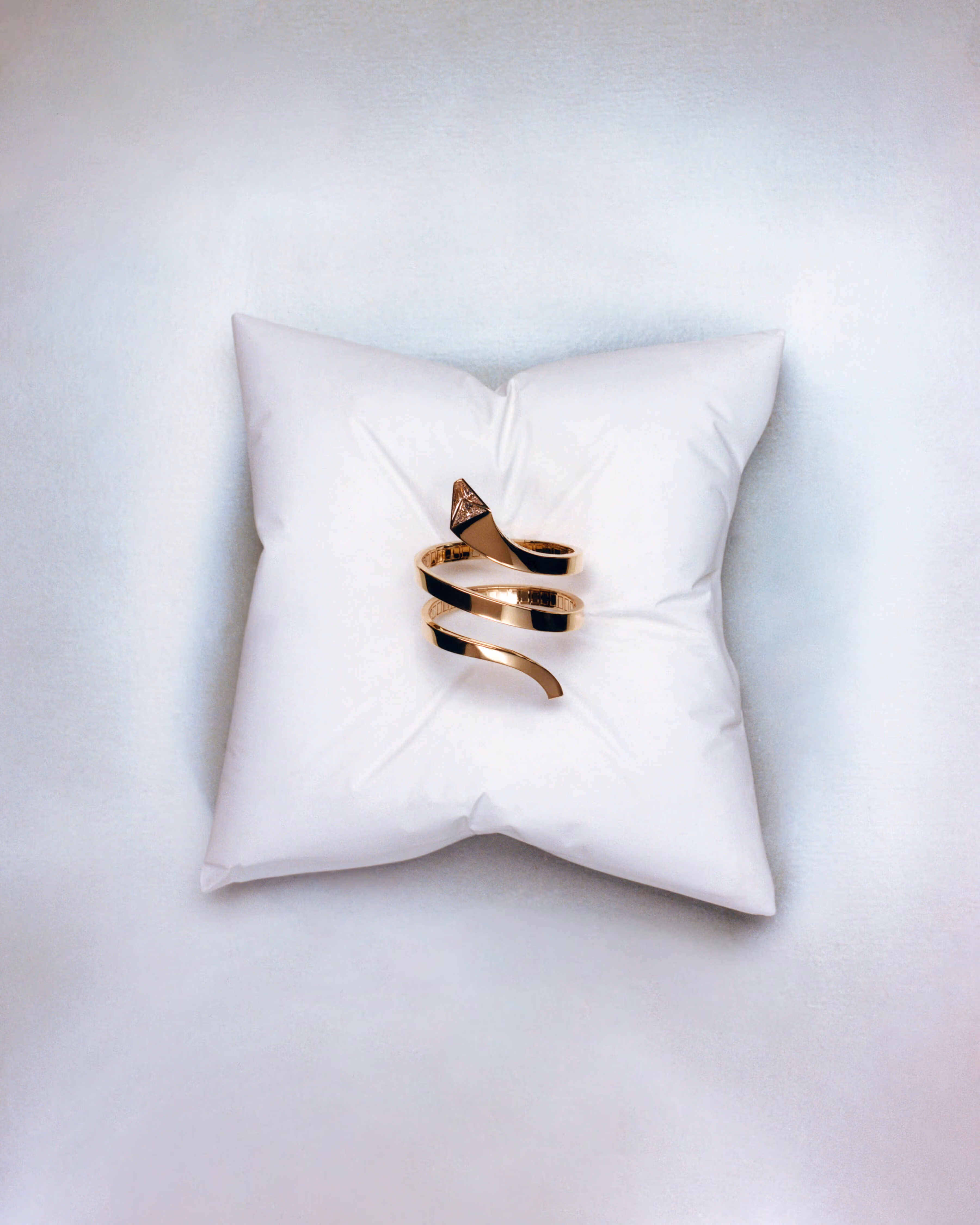 Bracelet by PRADA and pillow by BESSIE CHENG.
