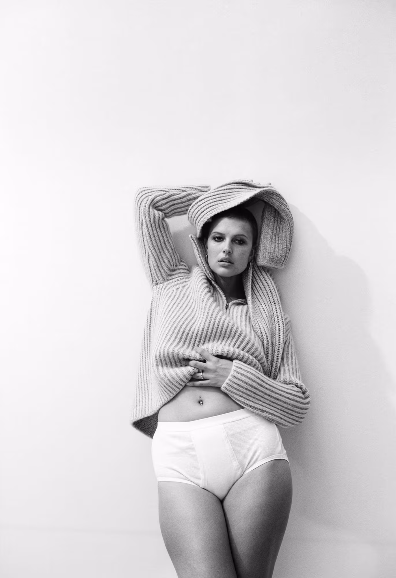 Celina wears sweater and scarf by ZEGNA