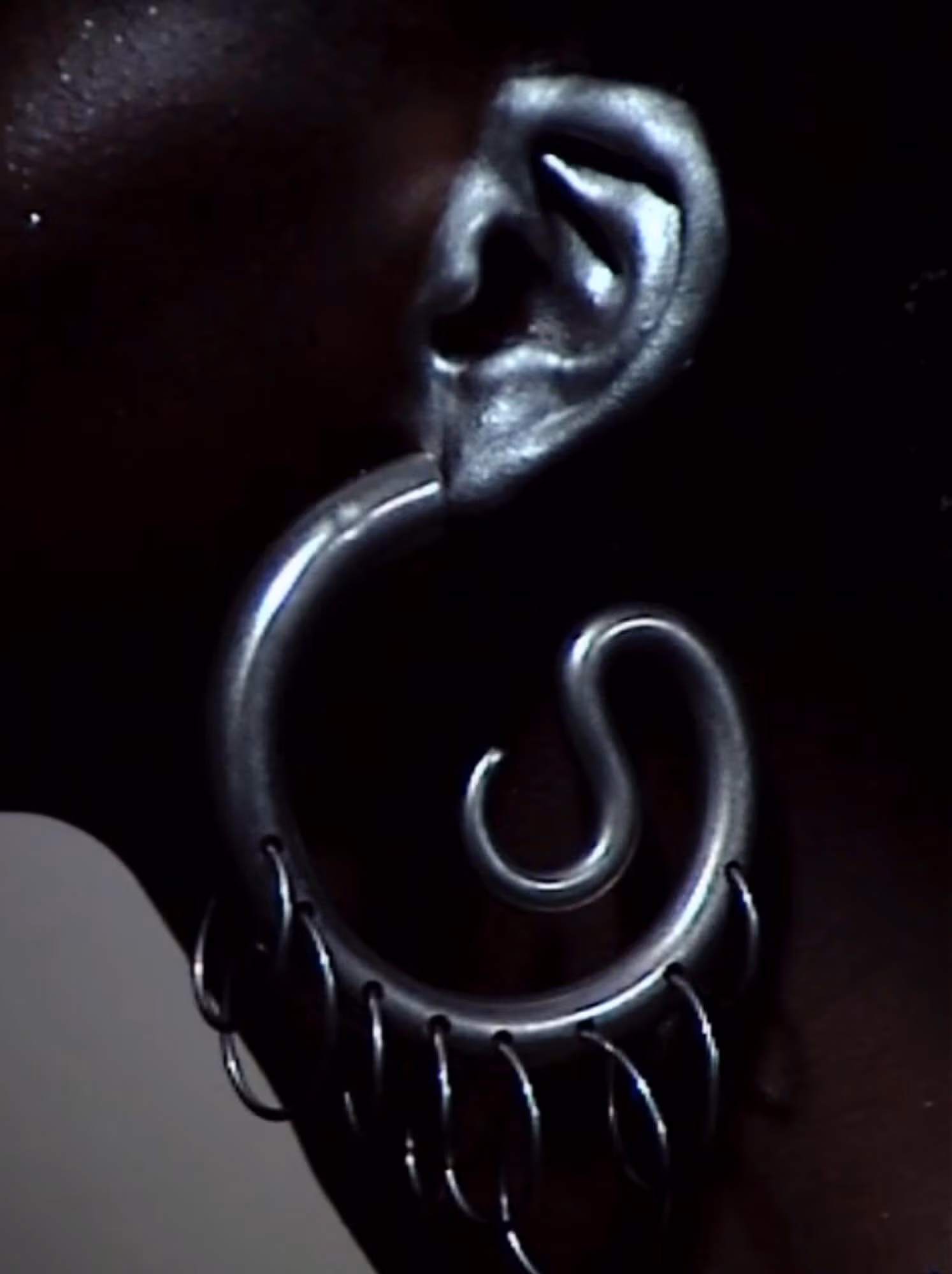 Anyier wears earring by PANCONESI.
