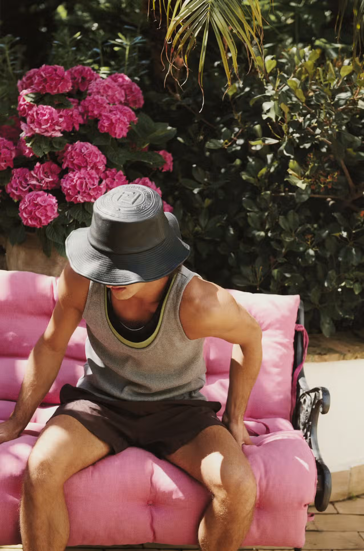 Antonio Del Vecchio wears shirt and hat by FENDI.