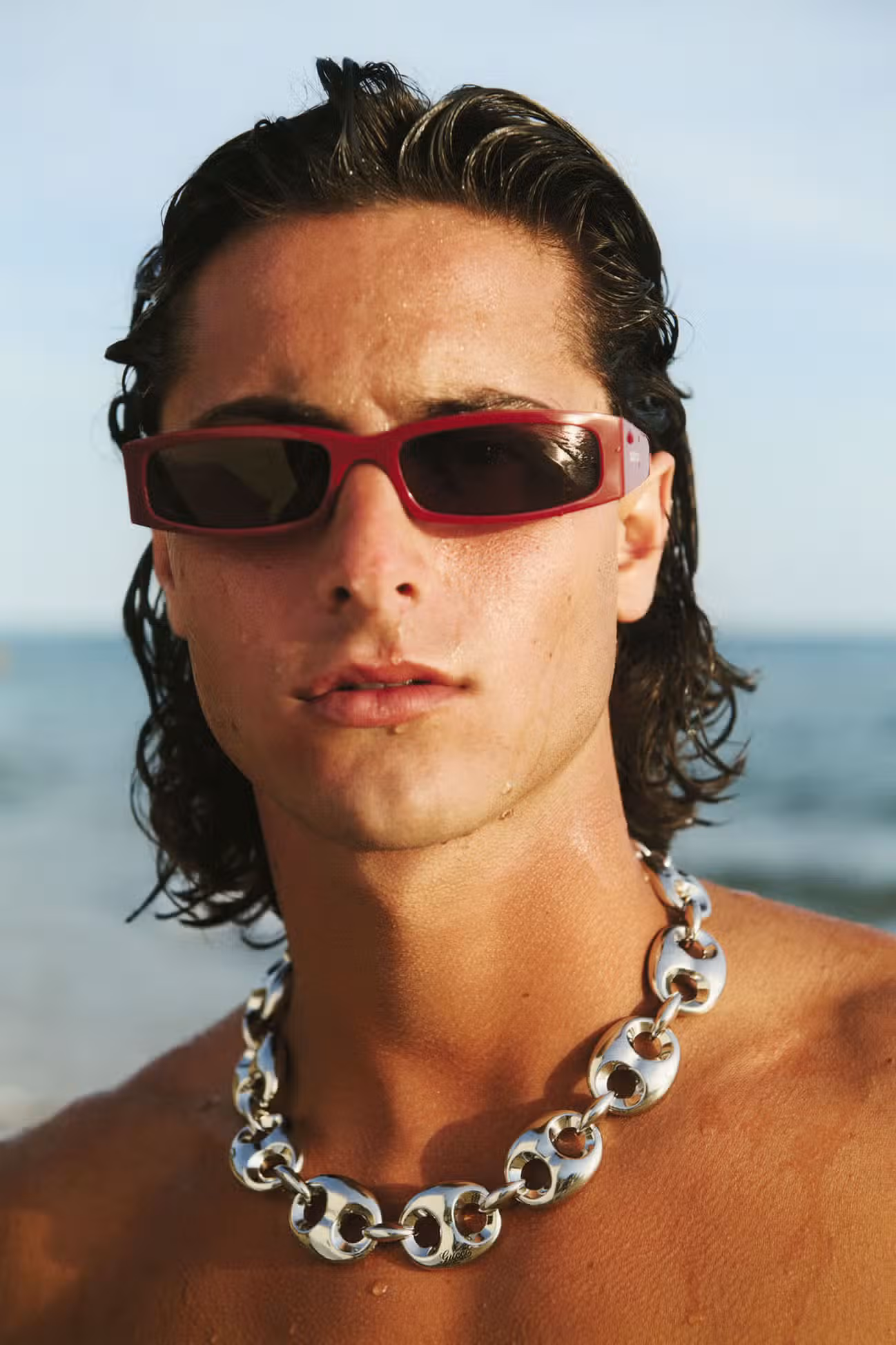 Antonio wears sunglasses and necklace by GUCCI.