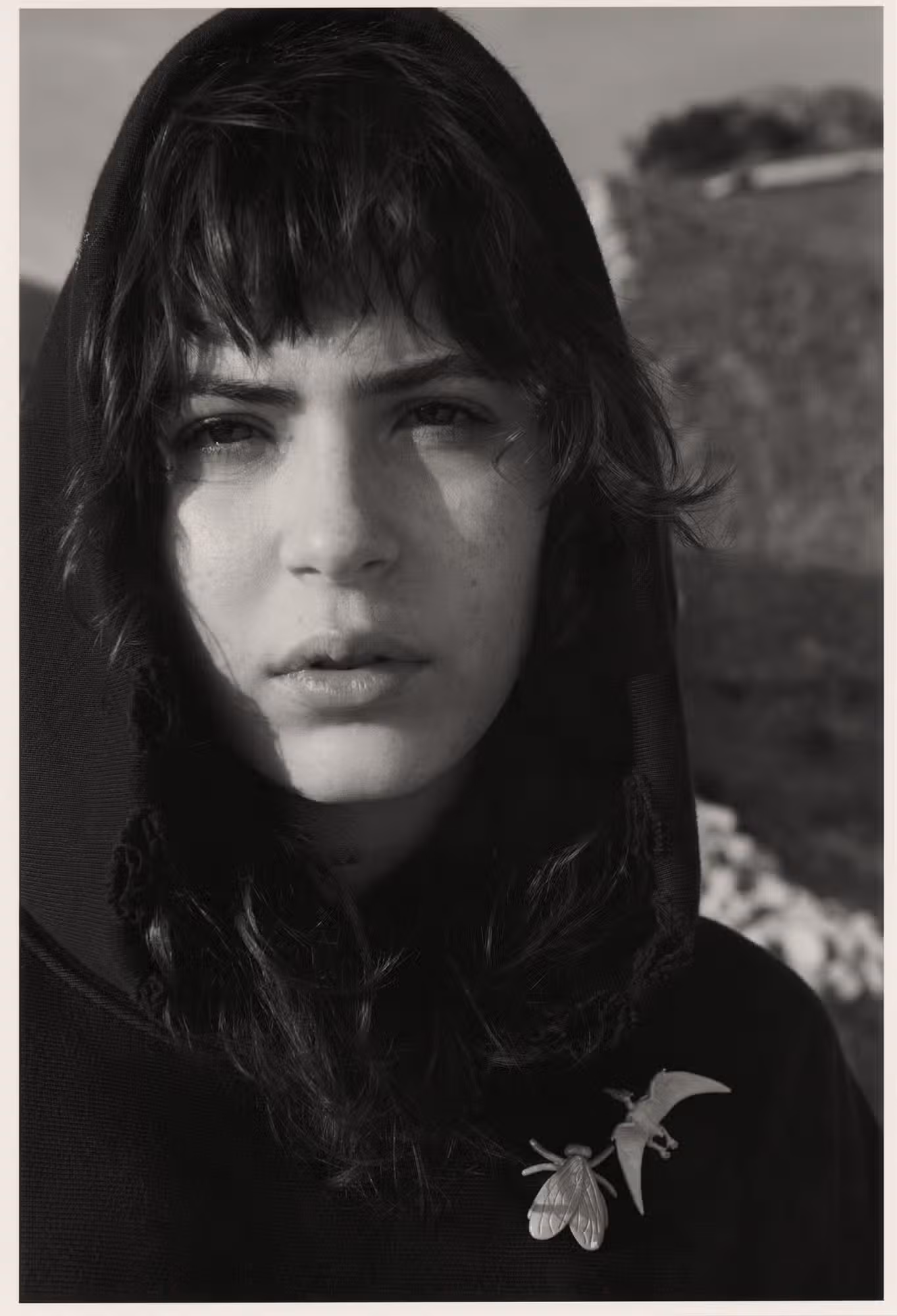 Sara wears hoodie and pins by COACH.