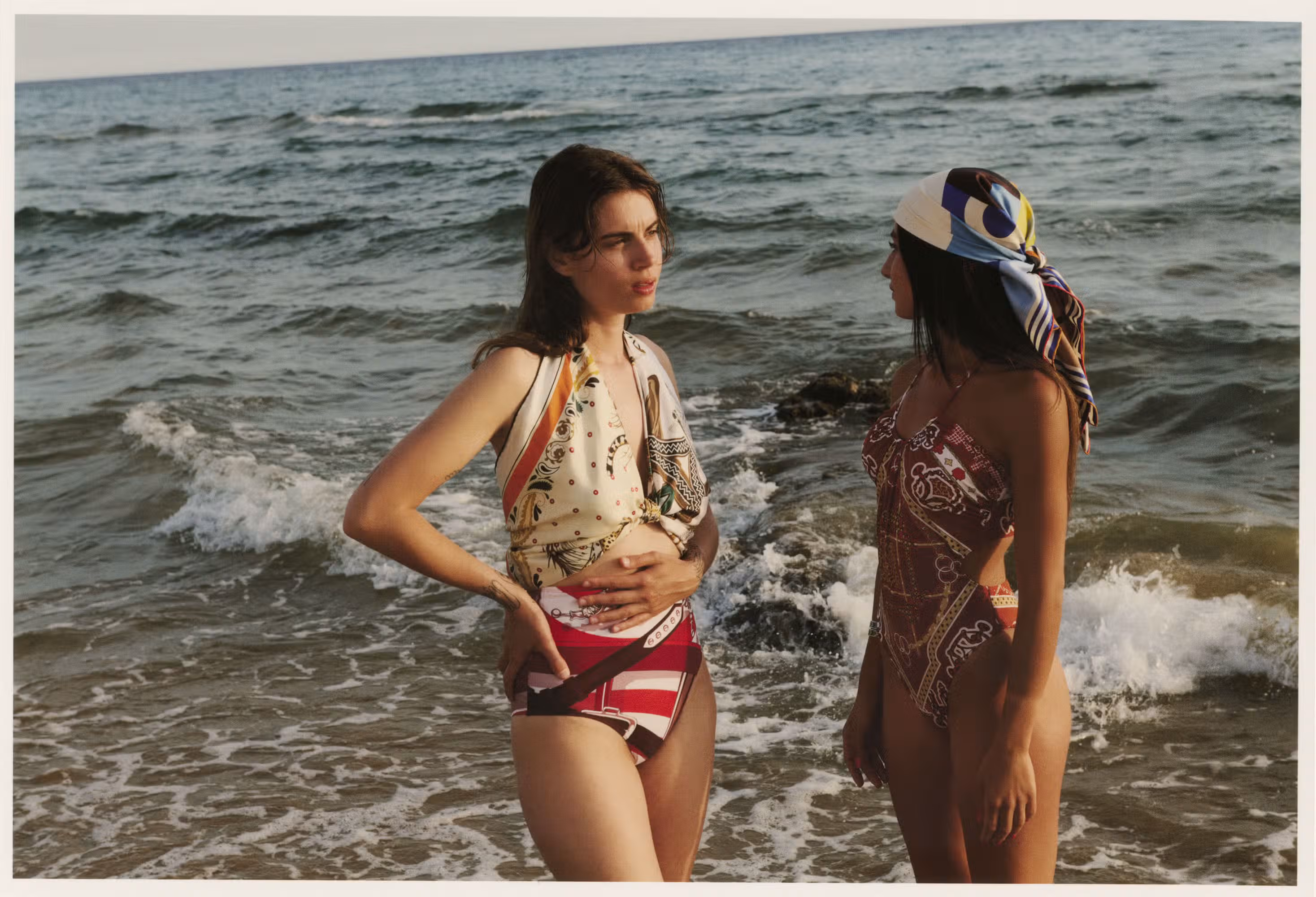 Janis wears swimsuit and scarf by HERMÈS. Asia wears swimsuit