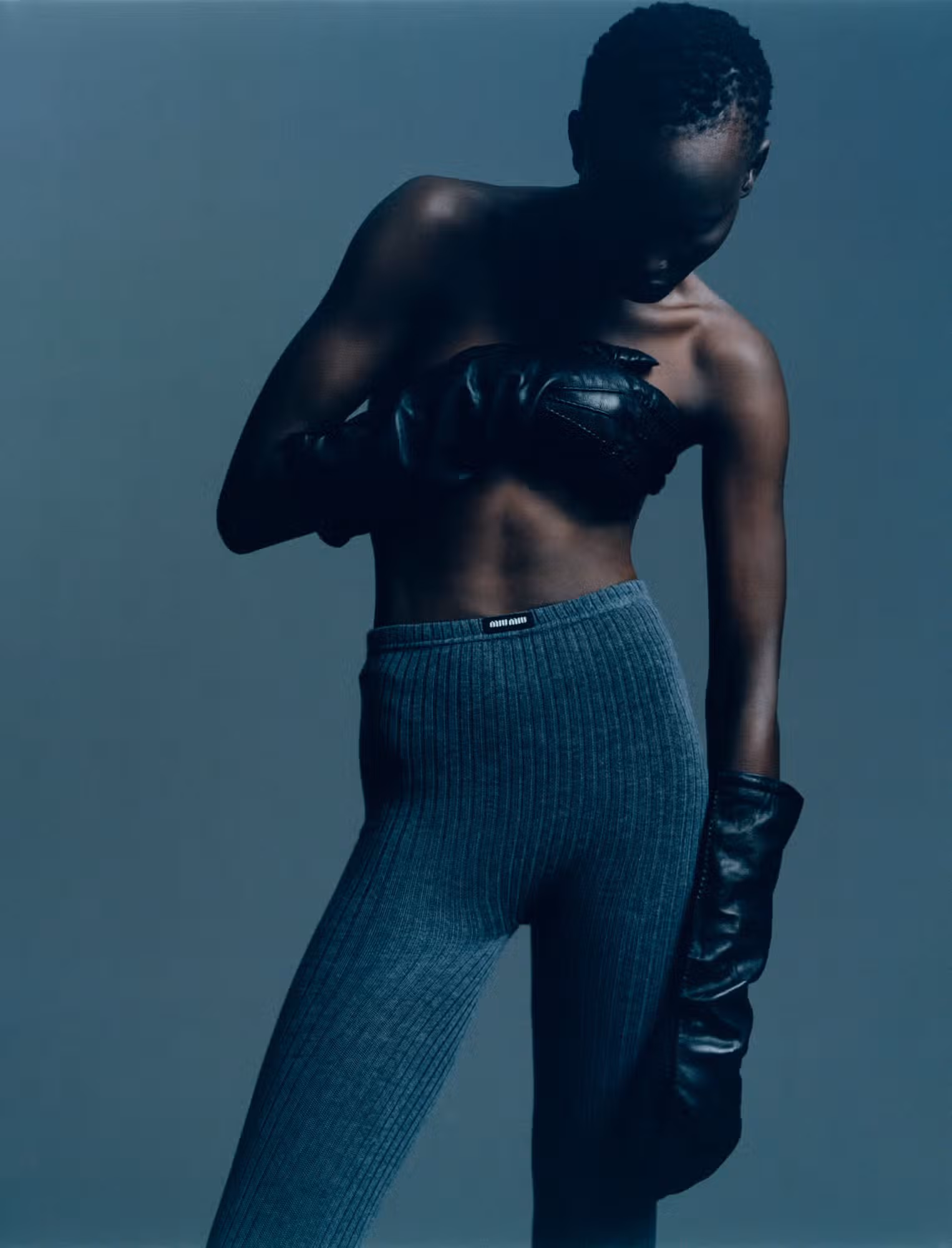 Atem wears gloves and tights by MIU MIU.
