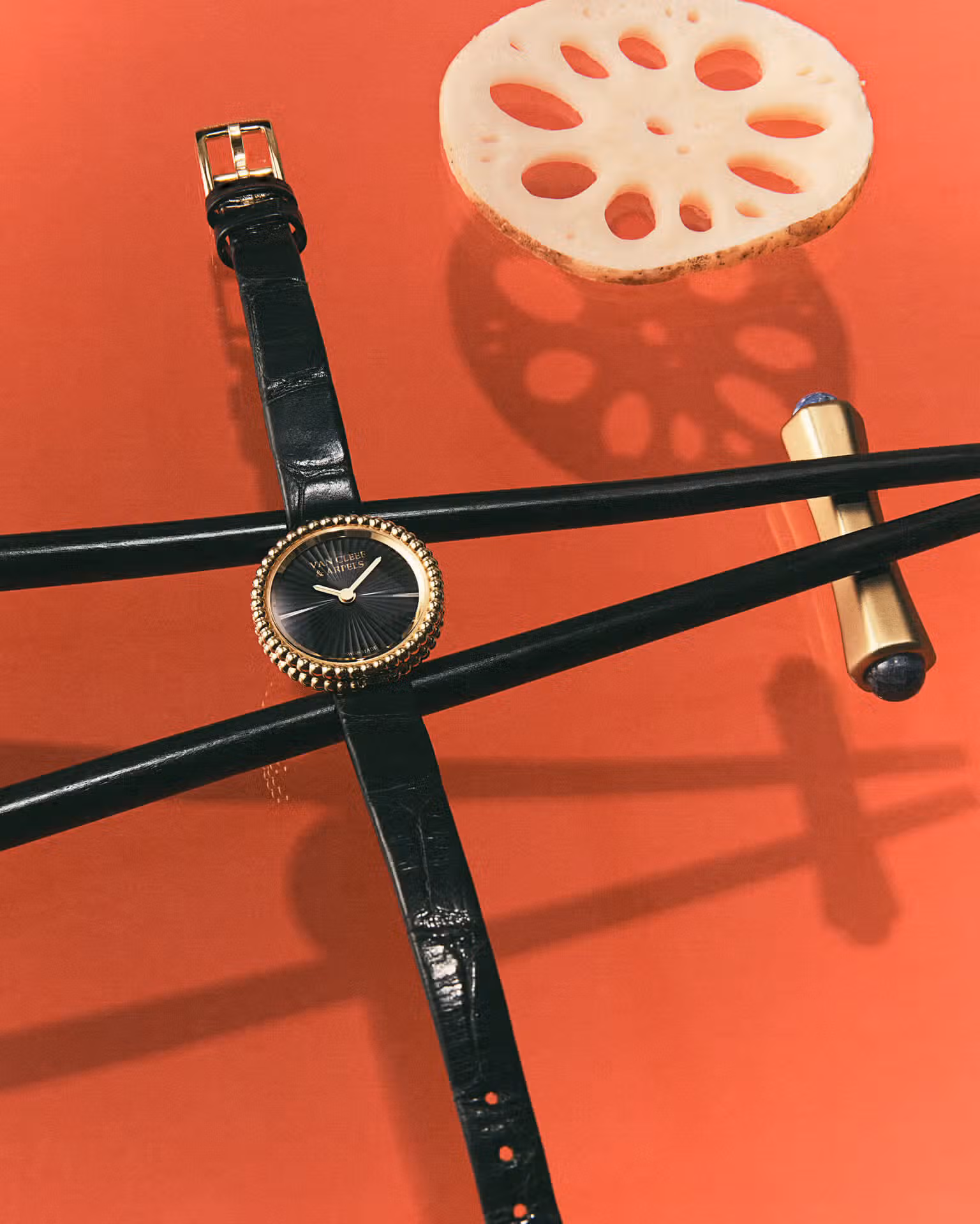 Watch by VAN CLEEF & ARPELS and chopsticks and rest by L’OBJET.