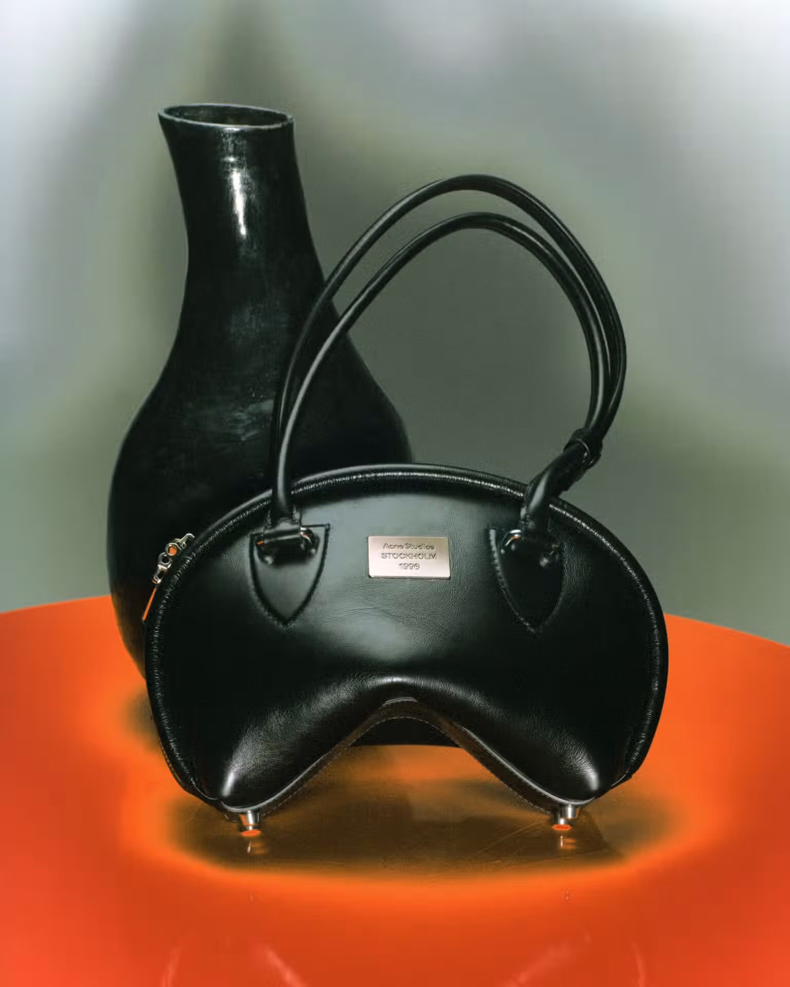 Bag by ACNE STUDIOS and vase by JUDI WONG.