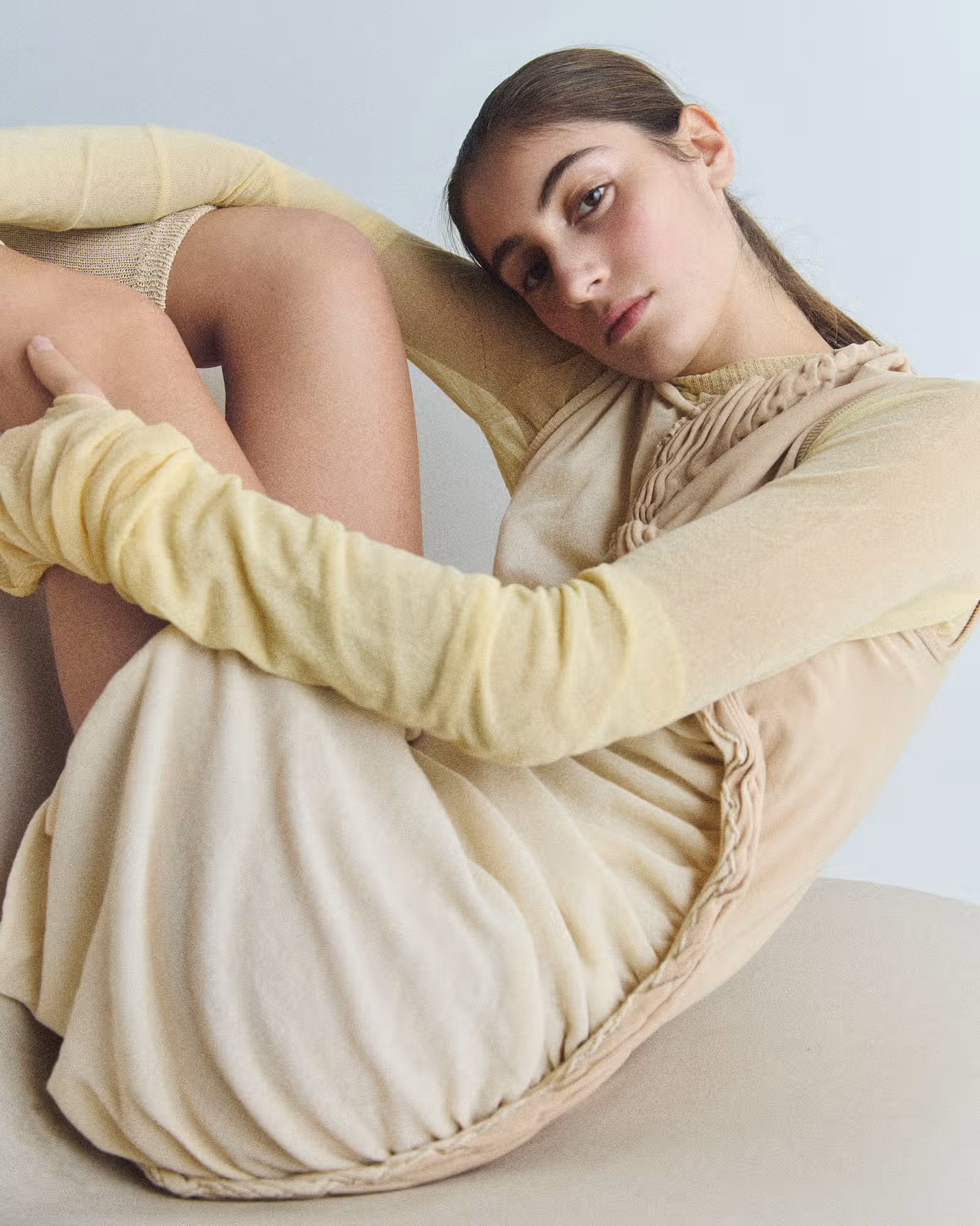 Sahteene wears full look by ISSEY MIYAKE.