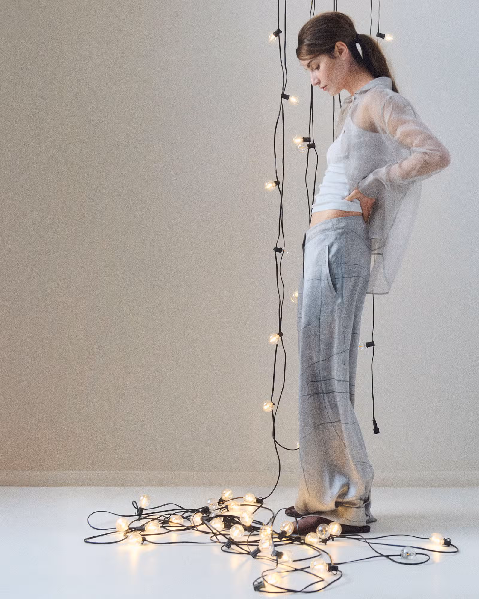 Sahteene wears shirt and pants by GIORGIO ARMANI