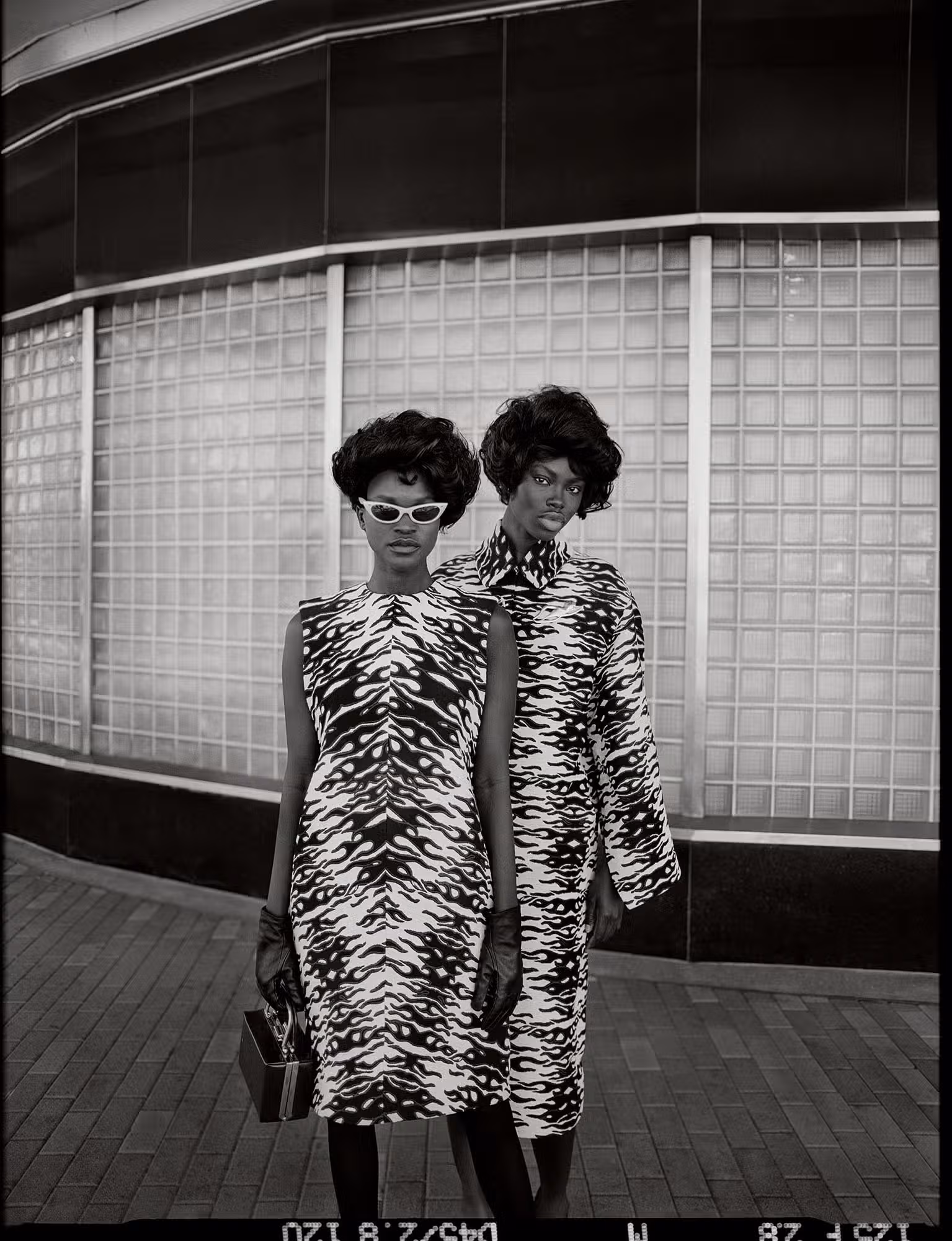 Awar Mou wears dress by TORY BURCH. Dija Kallon wears coat by TORY BURCH.