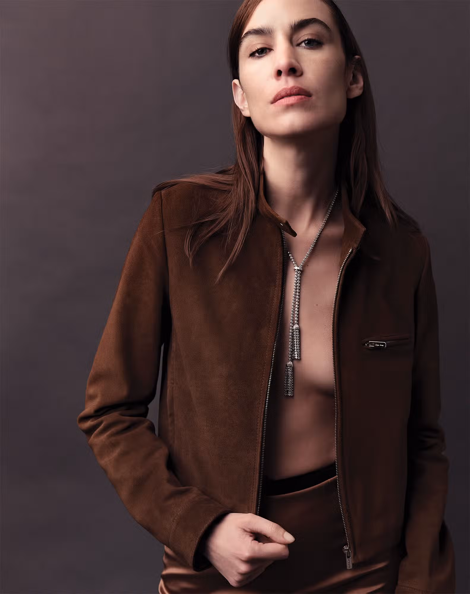 Alexa Chung wears jacket by MIU MIU and necklace by BOUCHERON.