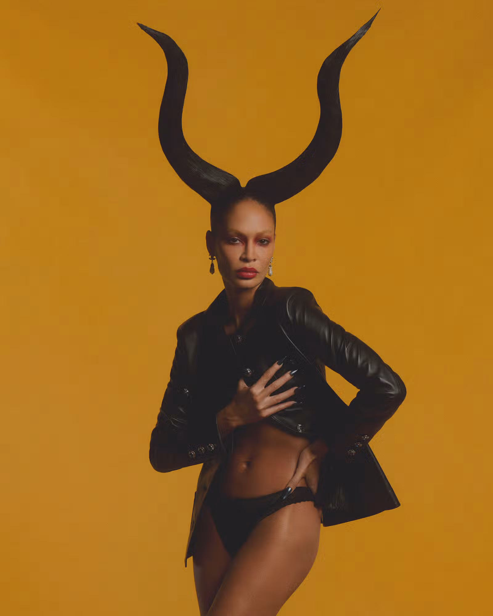 Joan Smalls wears jacket and earrings by CHANEL.