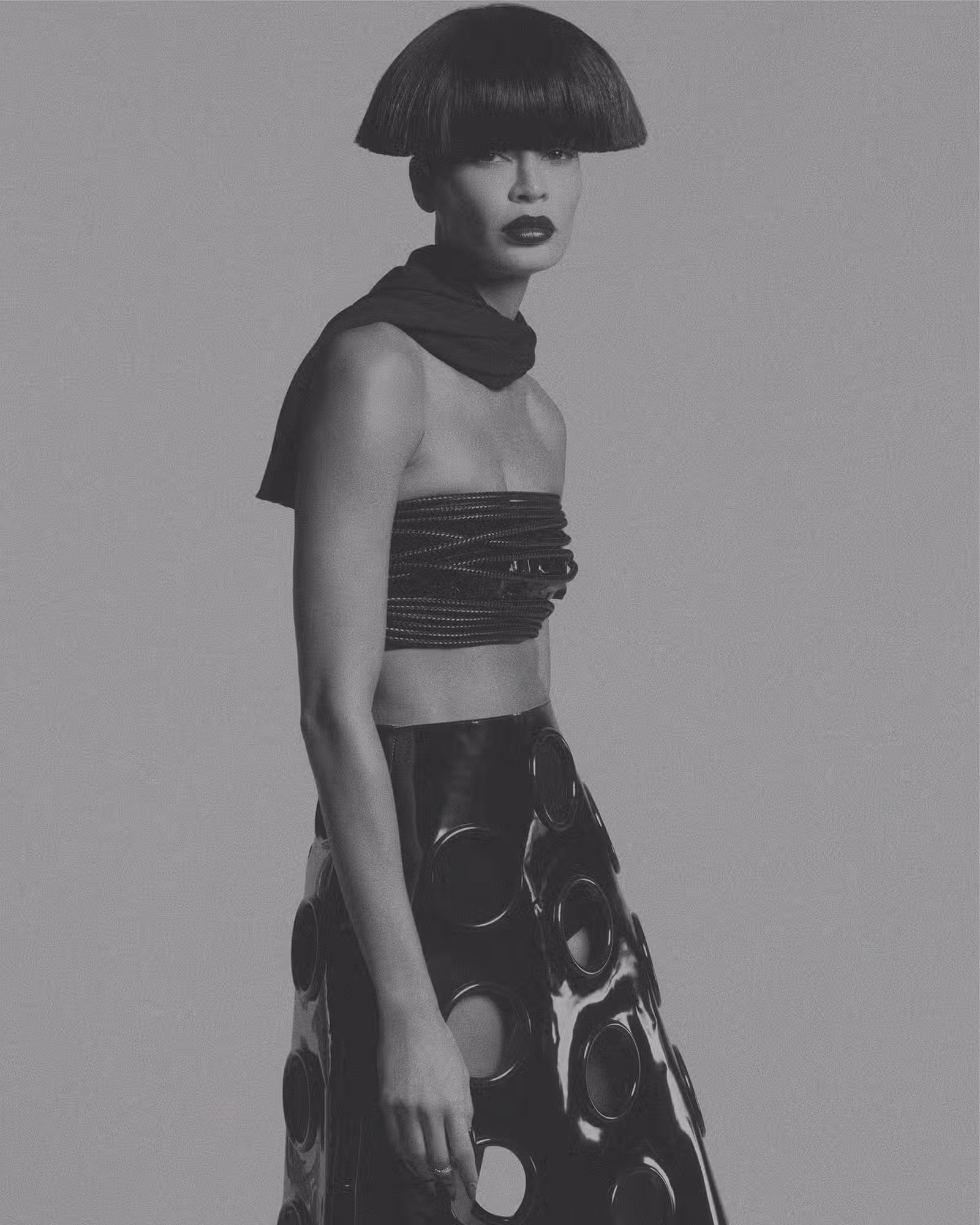 Joan wears sweater and skirt by PRADA and ring by VAN CLEEF & ARPELS.