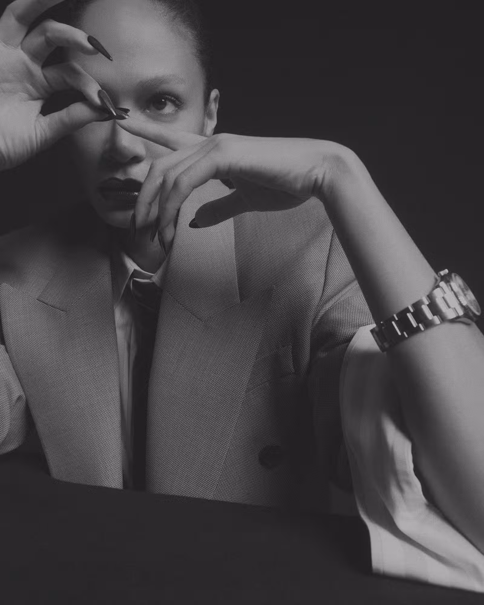 Joan wears full look by SAINT LAURENT and watch by ROLEX.